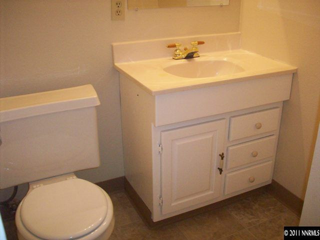 1415 Exeter Way Reno, NV 89503 - Photo 7 of 8 a bathroom with a sink a toilet and mirror