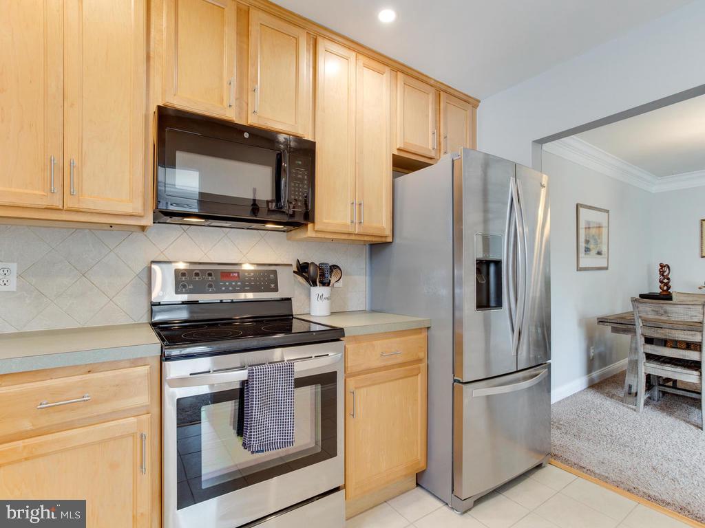 132 Oakwood Road Edgewater, MD 21037 - Photo 13 of 37 a kitchen with stainless steel appliances white cabinets and a stove top oven