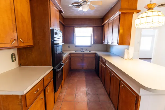 a kitchen with a sink and wooden cabinets