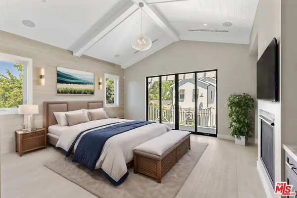 a spacious bedroom with a large bed and a large window