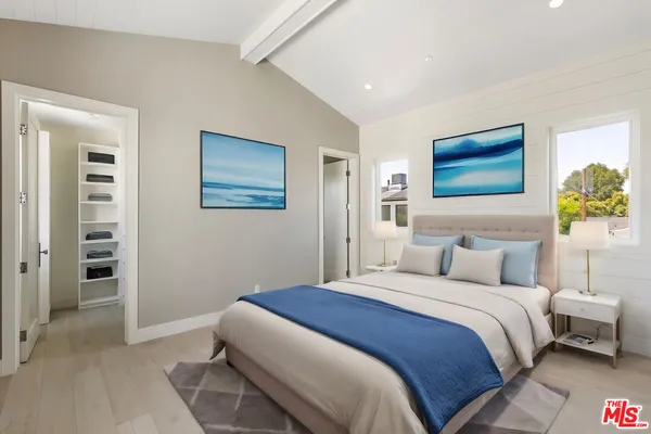 a bedroom with a bed and a painting on the wall