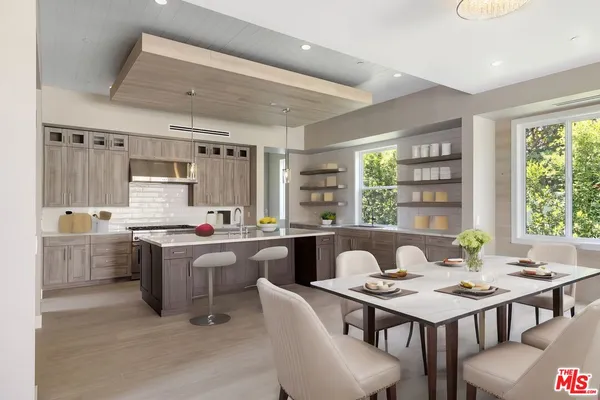 a kitchen that has a table and chairs in it