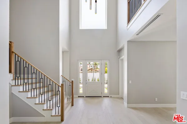 a view of an entryway with wooden floor