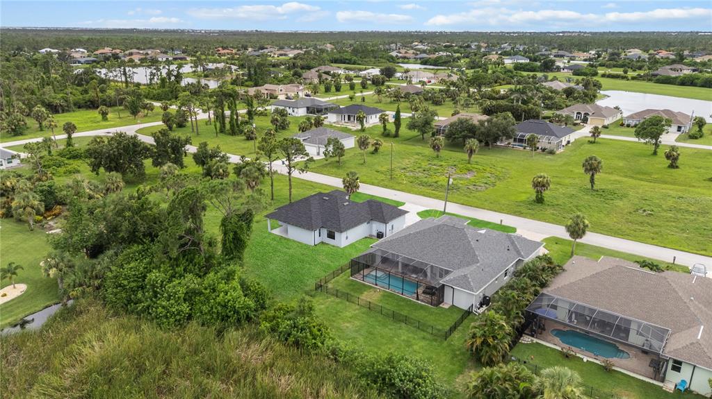 9 Tee View Road Rotonda West, FL 33947 - Photo 11 of 38 an aerial view of residential houses with outdoor space and lake view