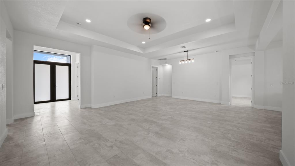 9 Tee View Road Rotonda West, FL 33947 - Photo 12 of 38 wooden floor in an empty room with a window