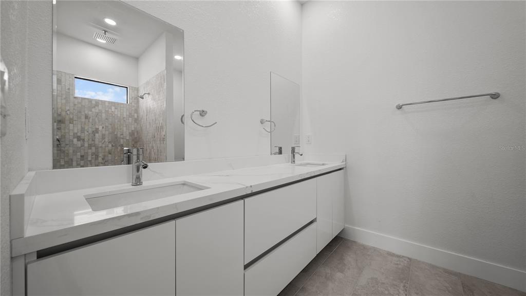 9 Tee View Road Rotonda West, FL 33947 - Photo 26 of 38 a bathroom with a sink and a mirror