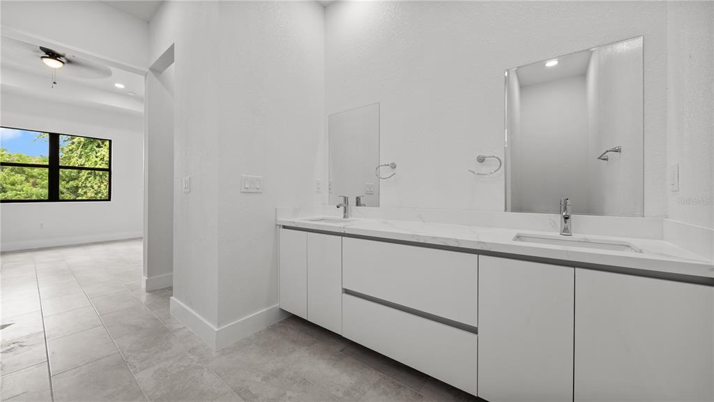 9 Tee View Road Rotonda West, FL 33947 - Photo 28 of 38 a bathroom with 2 sink and a mirror