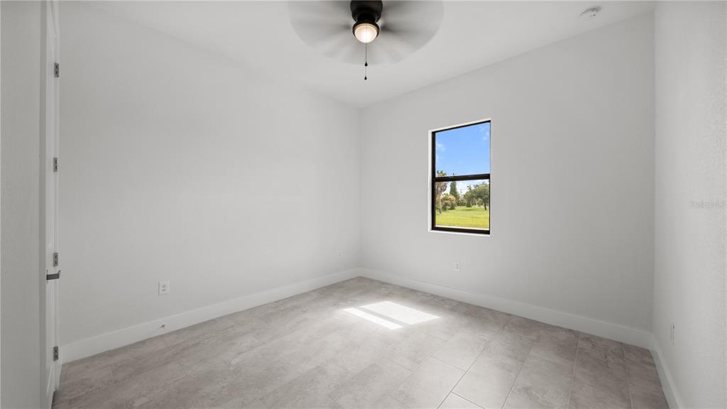 9 Tee View Road Rotonda West, FL 33947 - Photo 31 of 38 a view of an empty room with a window