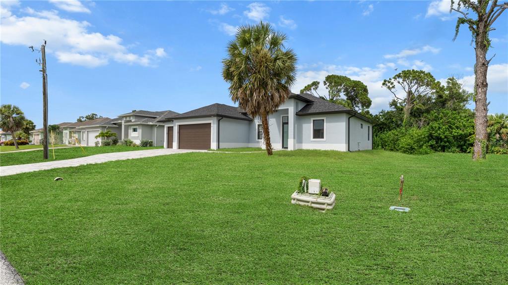 9 Tee View Road Rotonda West, FL 33947 - Photo 4 of 38 a house view with a garden space