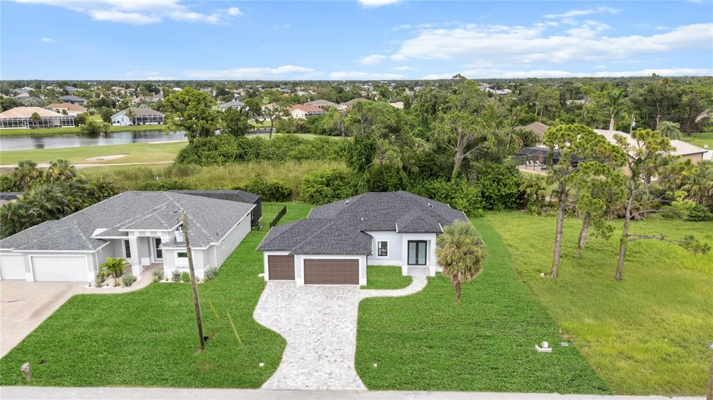 9 Tee View Road Rotonda West, FL 33947 - Photo 6 of 38 a view of house with garden space and ocean view
