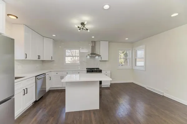 a kitchen with cabinets a sink and wooden floor
