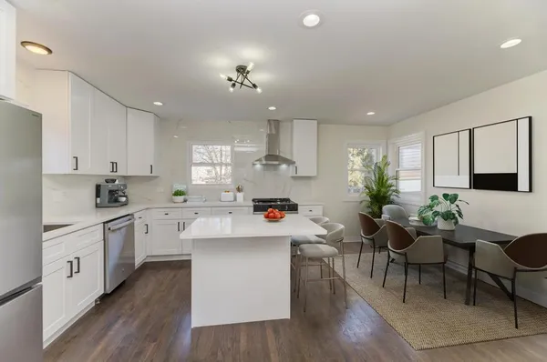 a room with white cabinets and white appliances