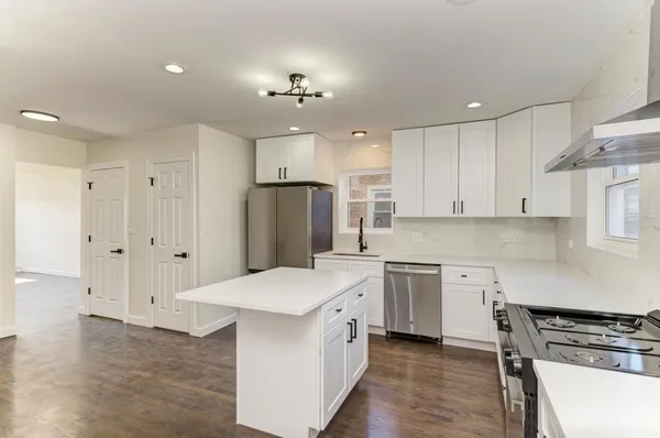 a kitchen with a white cabinets stove and refrigerator