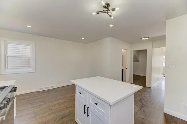 a view of a hallway with a kitchen