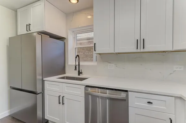 a kitchen with appliances cabinets and a counter top space