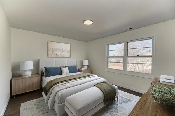 a bedroom with a bed and a window