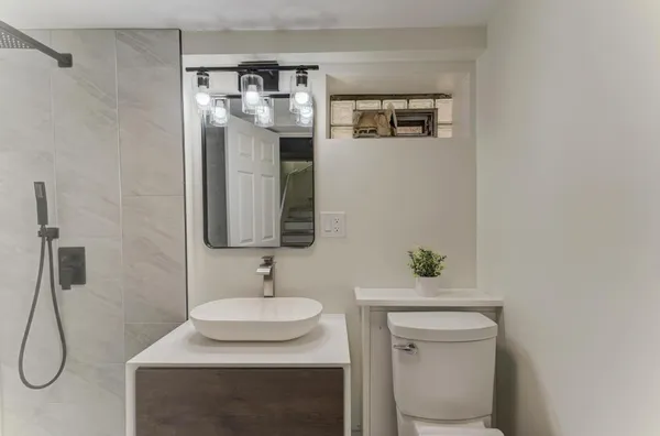 a bathroom with a sink toilet and shower