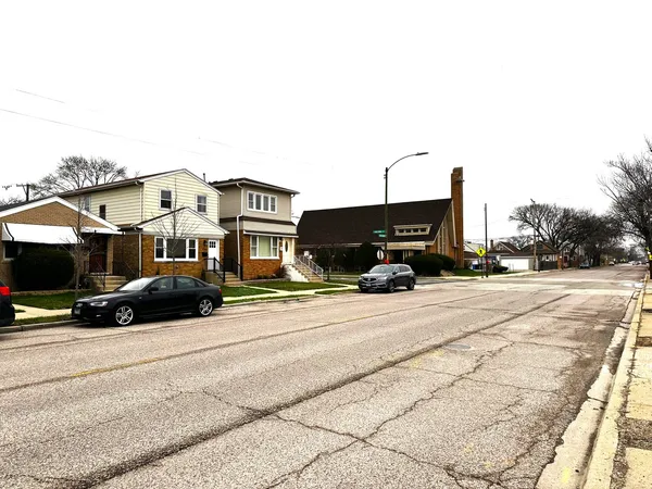 a view of street with parked cars
