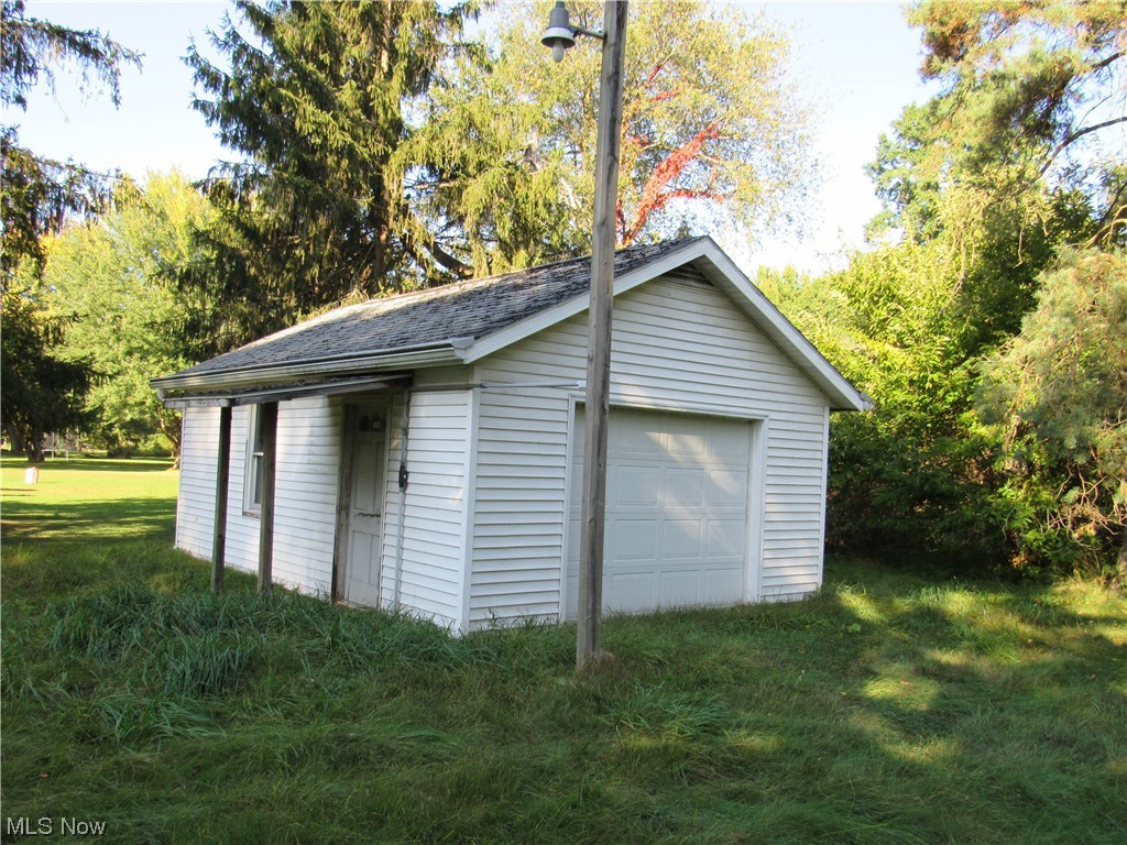 6986 Reed Road Conneaut, OH 44030 - Photo 3 of 22 Garage with a yard