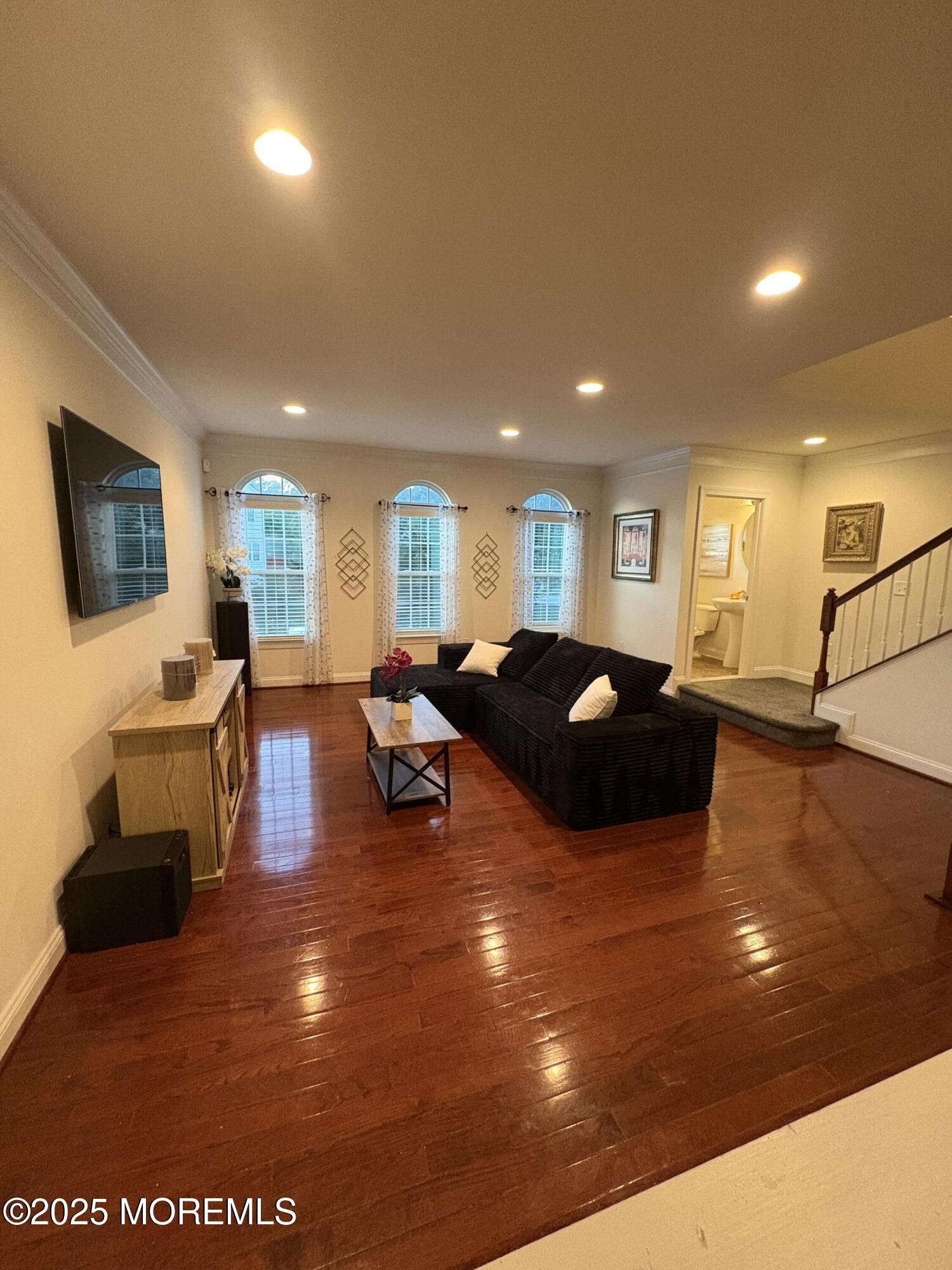 63 Pate Drive Middletown, NJ 07748 - Photo 15 of 50 a living room with lots of furniture and a flat screen tv