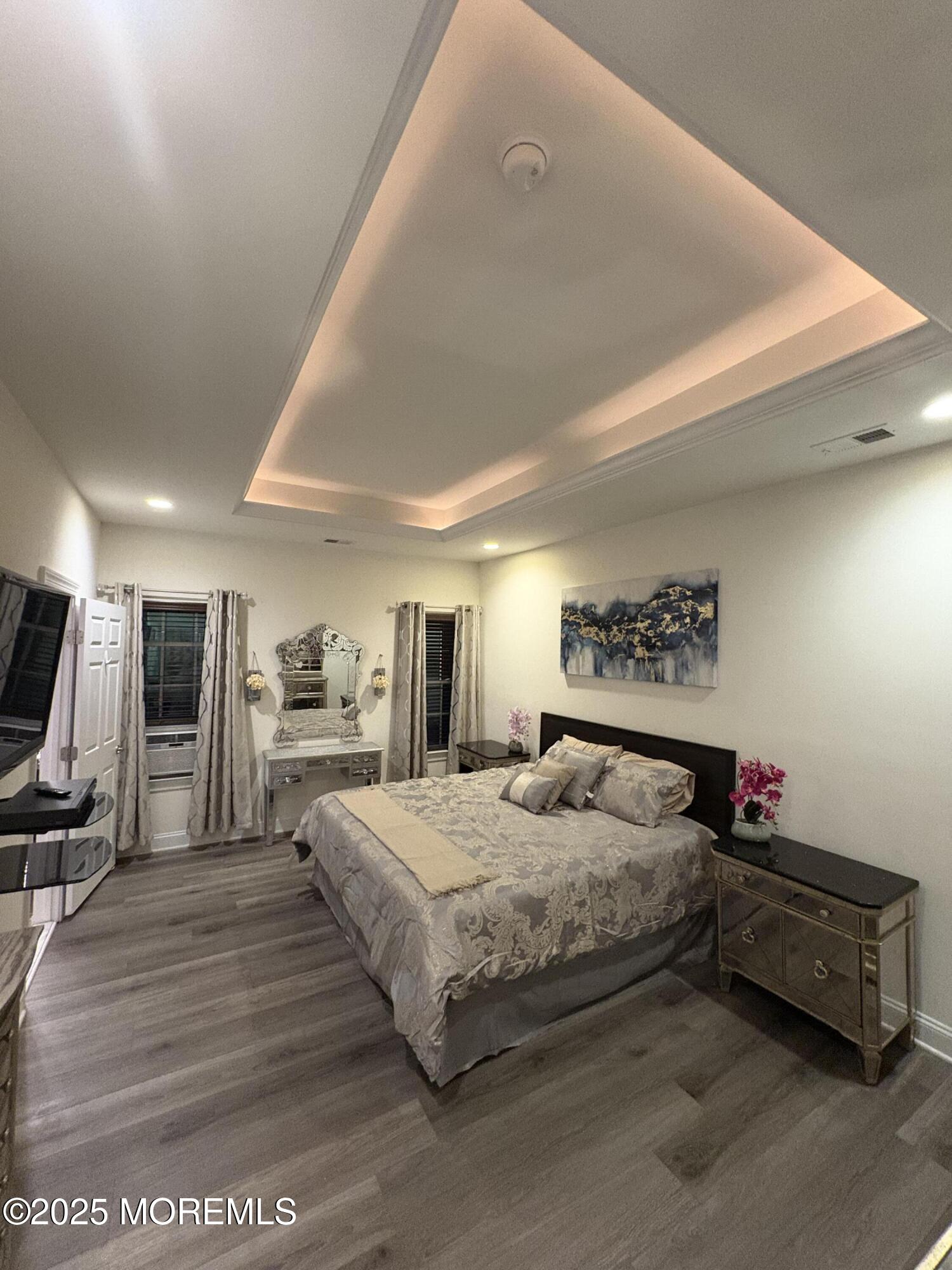 63 Pate Drive Middletown, NJ 07748 - Photo 18 of 50 a spacious bedroom with a bed a dresser and many windows