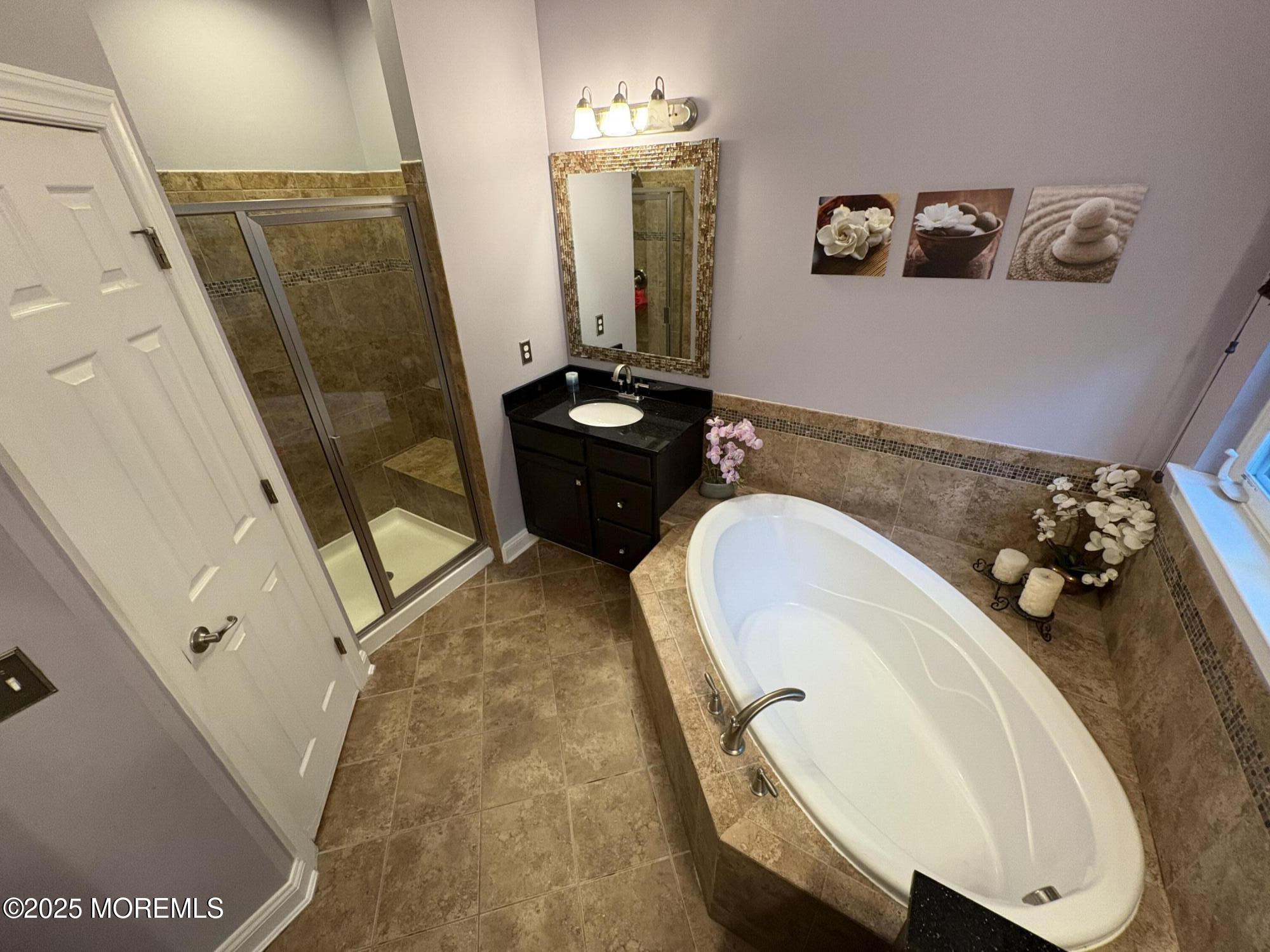 63 Pate Drive Middletown, NJ 07748 - Photo 22 of 50 a bathroom with a sink and mirror with bathtub