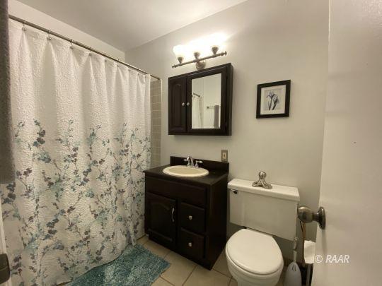 413 Karin Street Ridgecrest, CA 93555 - Photo 5 of 20 a bathroom with a toilet a sink and mirror