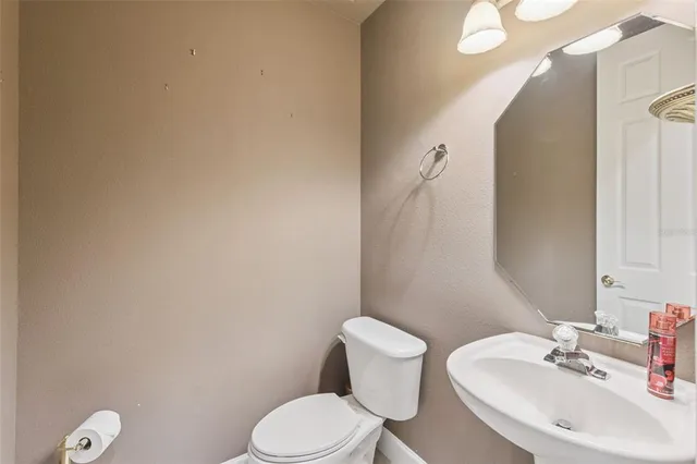 an empty room with windows and ceiling fan