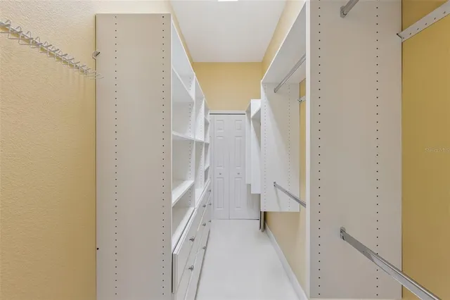a view of walk in closet with empty racks