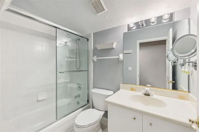 a view of an empty room with a chandelier fan