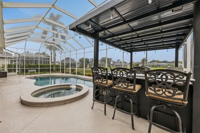 a kitchen with granite countertop a sink a counter space appliances and cabinets