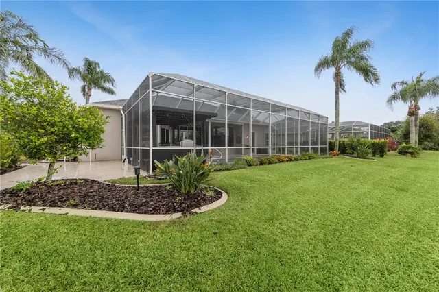a aerial view of a house with a yard and large trees