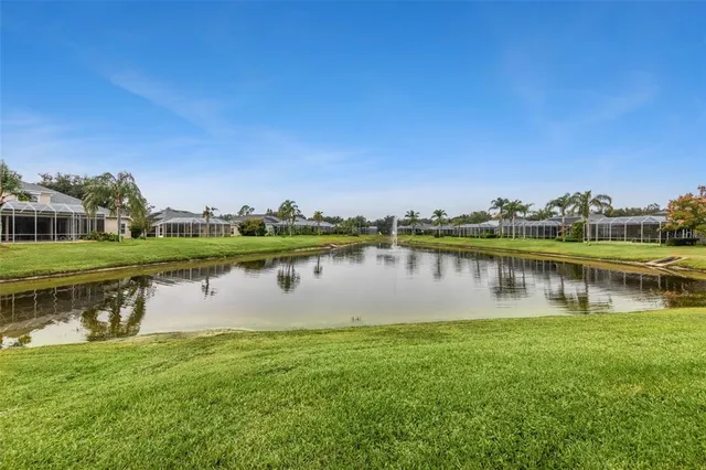 a front view of a house with a yard and potted plants