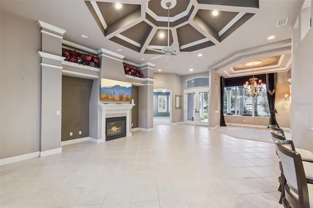 a view of an entryway with a fireplace and a chandelier