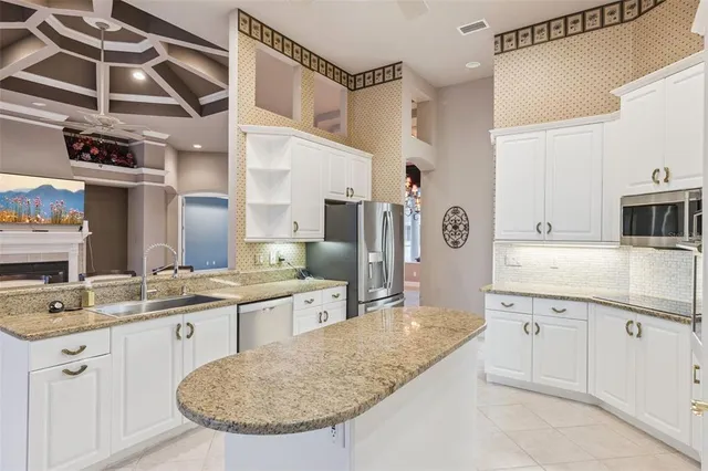 a bathroom with a granite countertop sink a mirror and shower