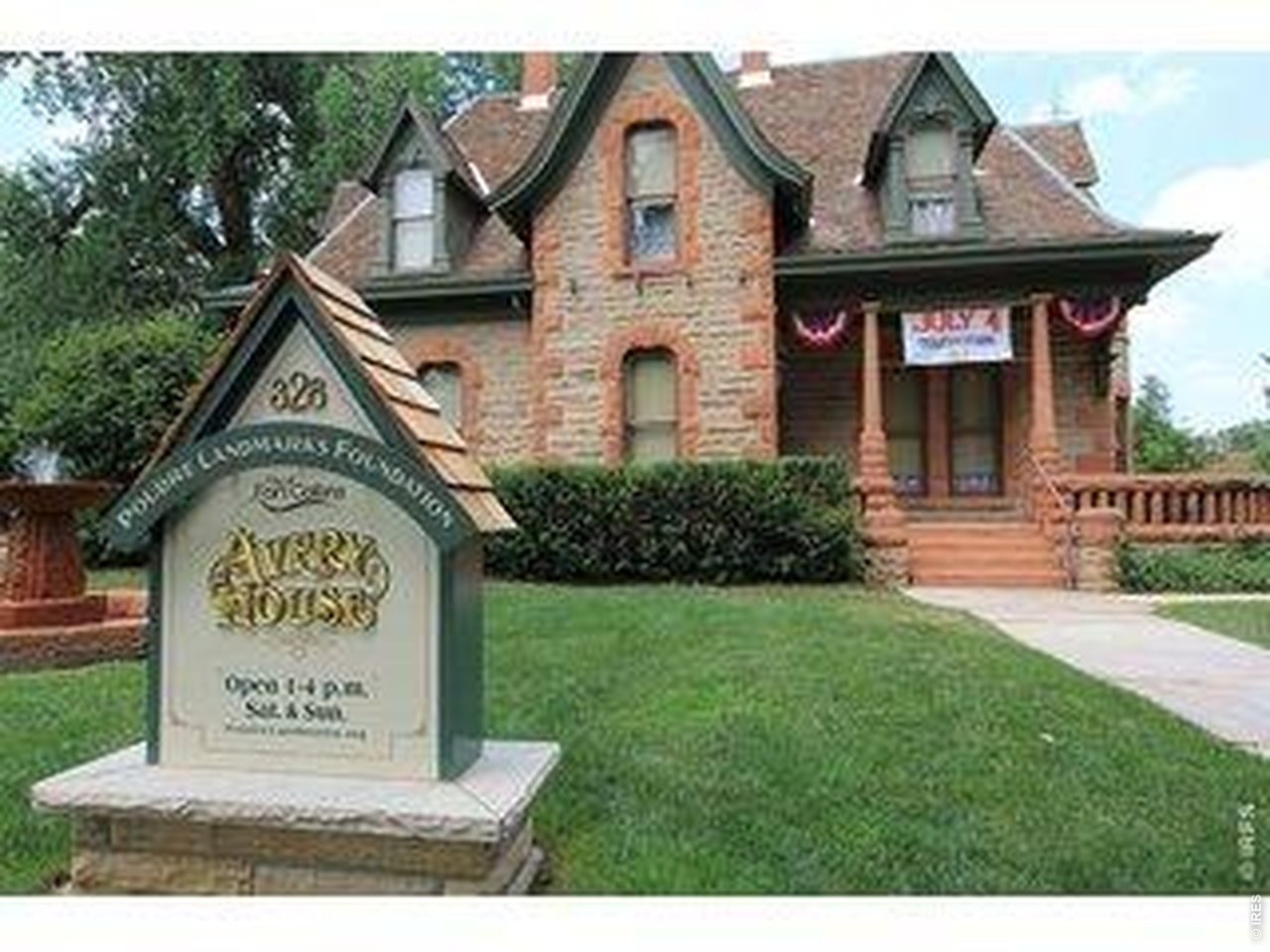 809 East Myrtle Street Fort Collins, CO 80524 - Photo 19 of 23 a view of a brick house with a small yard and large trees