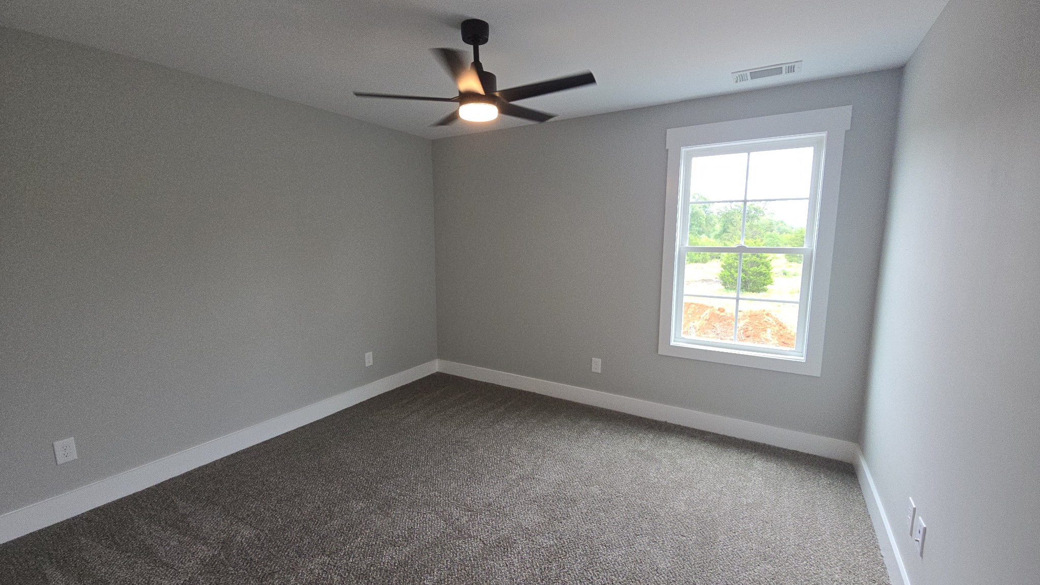 11533 Karo Road Bell Buckle, TN 37020 - Photo 13 of 22 an empty room with a window and a fan