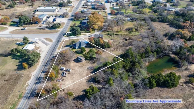 an aerial view of house with a yard and ocean view