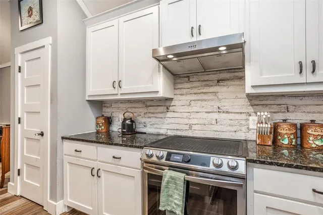 a stove top oven sitting inside of a kitchen