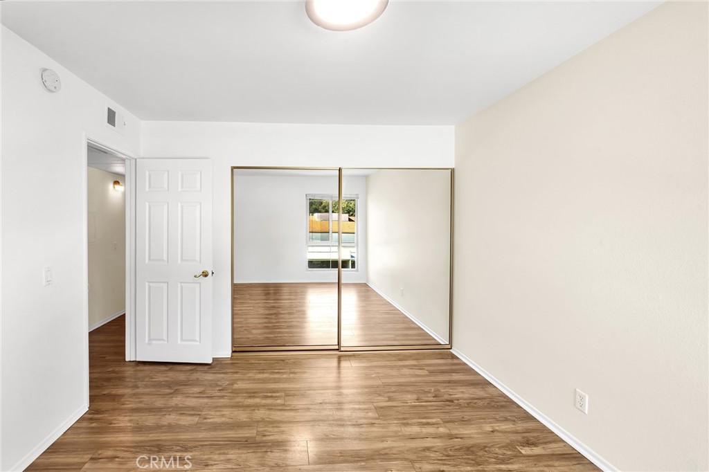23677 Park Capri, Unit 20 Calabasas, CA 91302 - Photo 13 of 19 a view of a hallway with wooden floor and staircase