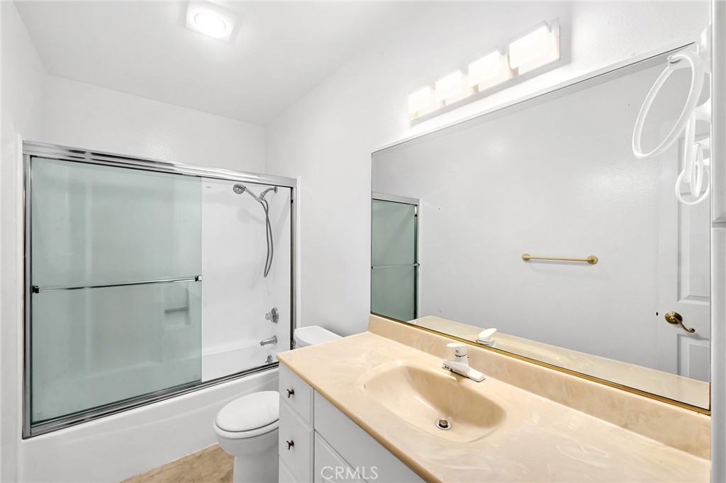 23677 Park Capri, Unit 20 Calabasas, CA 91302 - Photo 15 of 19 a bathroom with a sink vanity granite toilet and shower