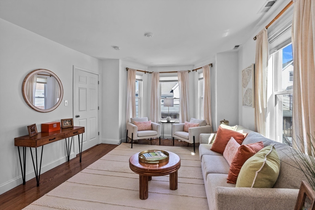 98 Flint Street, Unit 2 Somerville, MA 02145 - Photo 11 of 40 a living room with furniture and a large window