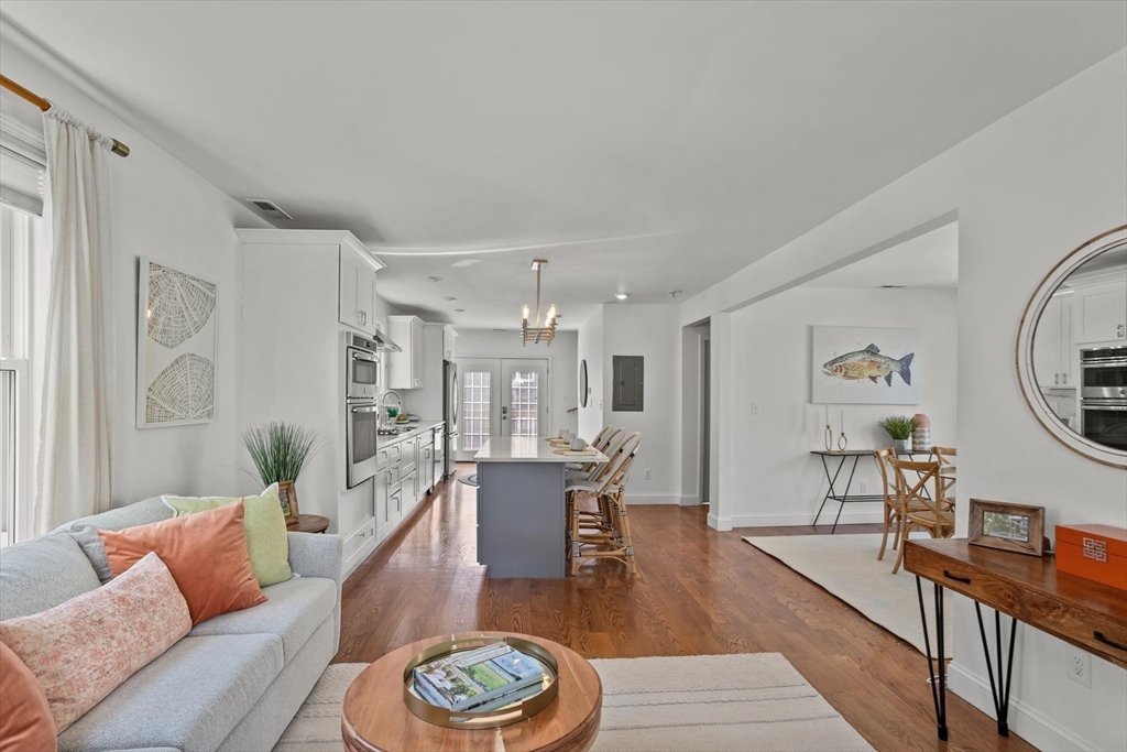 98 Flint Street, Unit 2 Somerville, MA 02145 - Photo 13 of 40 a living room with furniture and wooden floor
