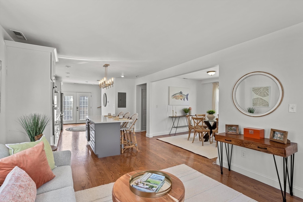 98 Flint Street, Unit 2 Somerville, MA 02145 - Photo 14 of 40 a living room with furniture a wooden floor and a dining table