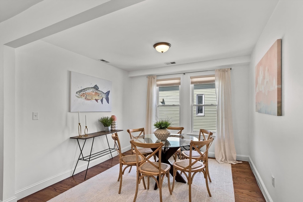 98 Flint Street, Unit 2 Somerville, MA 02145 - Photo 15 of 40 a view of a dining room with furniture and wooden floor
