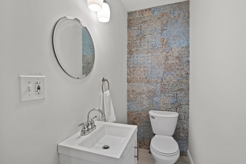 98 Flint Street, Unit 2 Somerville, MA 02145 - Photo 19 of 40 a bathroom with a toilet a sink and mirror