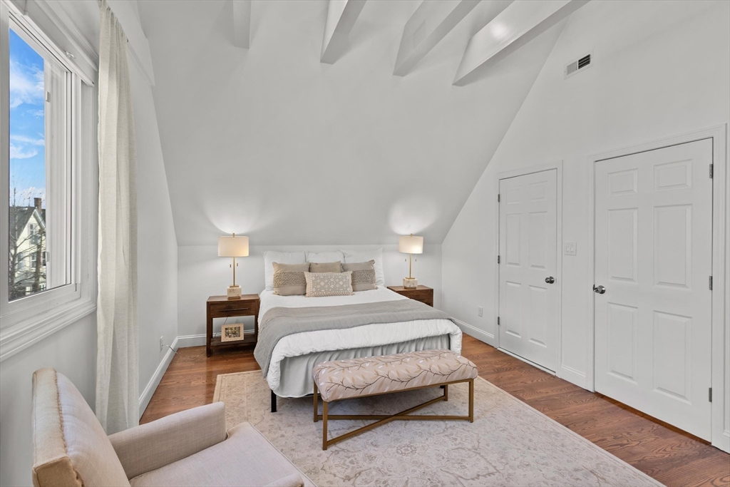 98 Flint Street, Unit 2 Somerville, MA 02145 - Photo 22 of 40 a bedroom with a bed and a couch