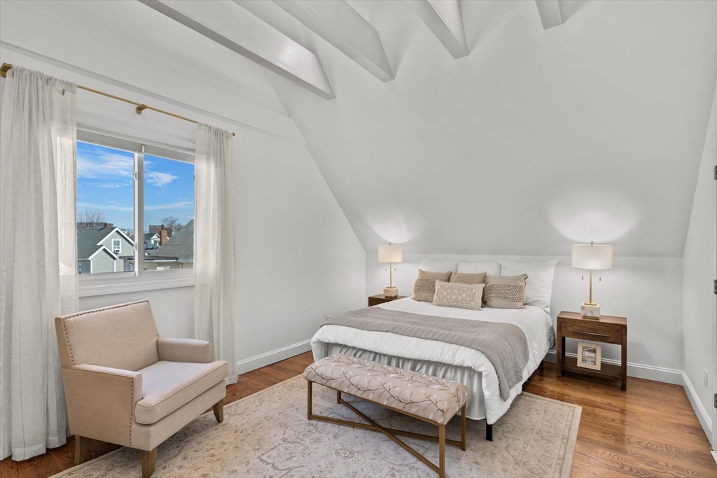 98 Flint Street, Unit 2 Somerville, MA 02145 - Photo 24 of 40 a bedroom with a bed and a couch