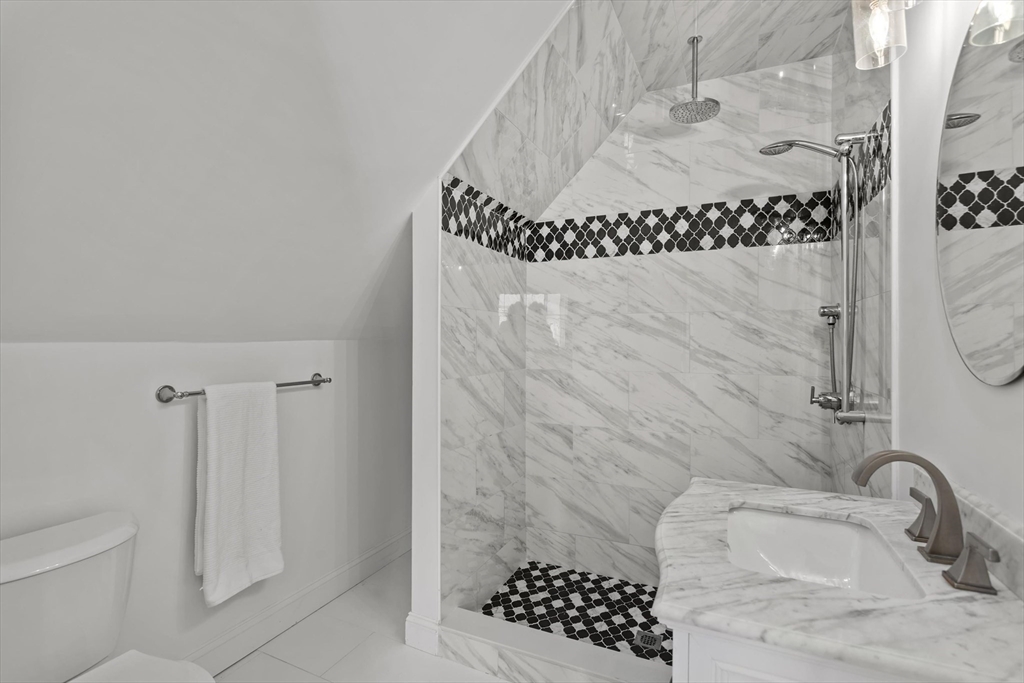 98 Flint Street, Unit 2 Somerville, MA 02145 - Photo 25 of 40 a bathroom with a granite countertop sink a toilet and shower