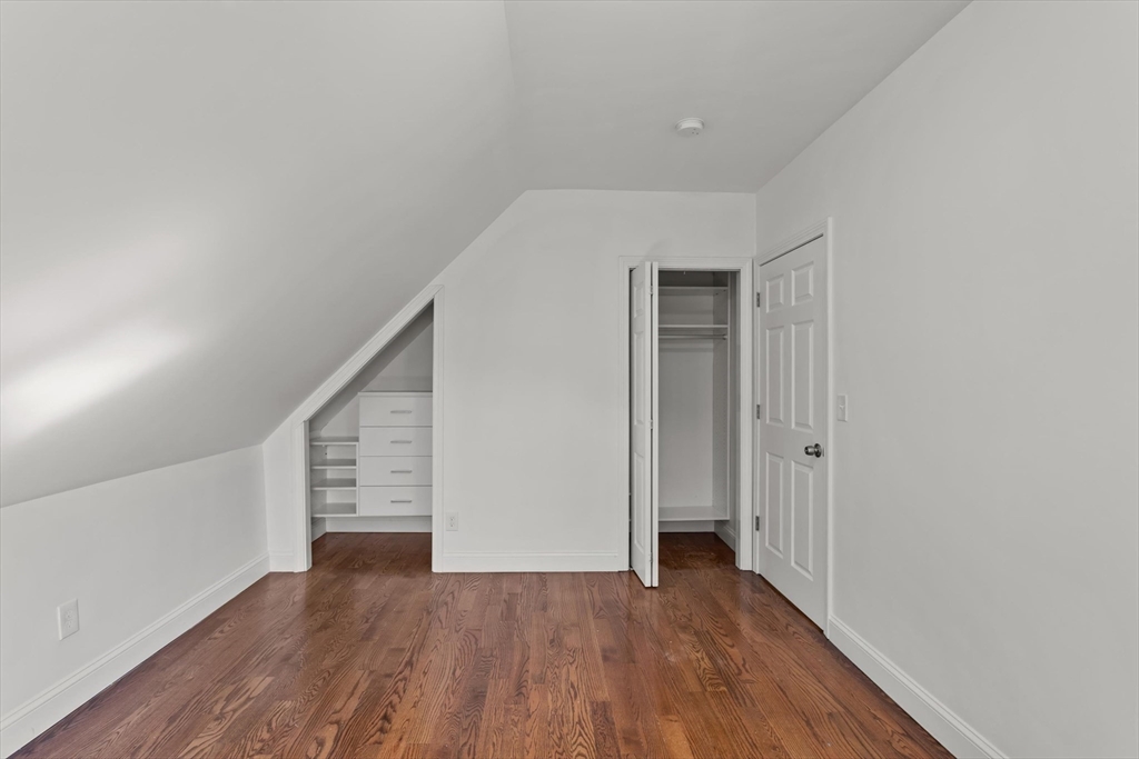 98 Flint Street, Unit 2 Somerville, MA 02145 - Photo 28 of 40 a view of an empty room with wooden floor